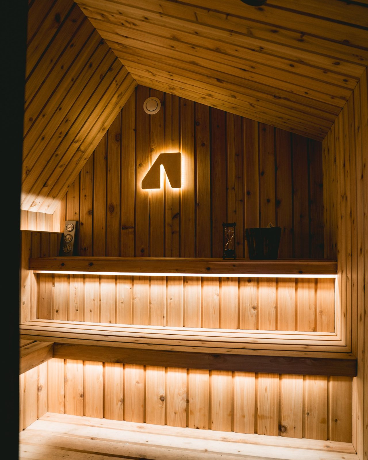 Cedar interior of a Wavyroom sauna, benches lit from below
